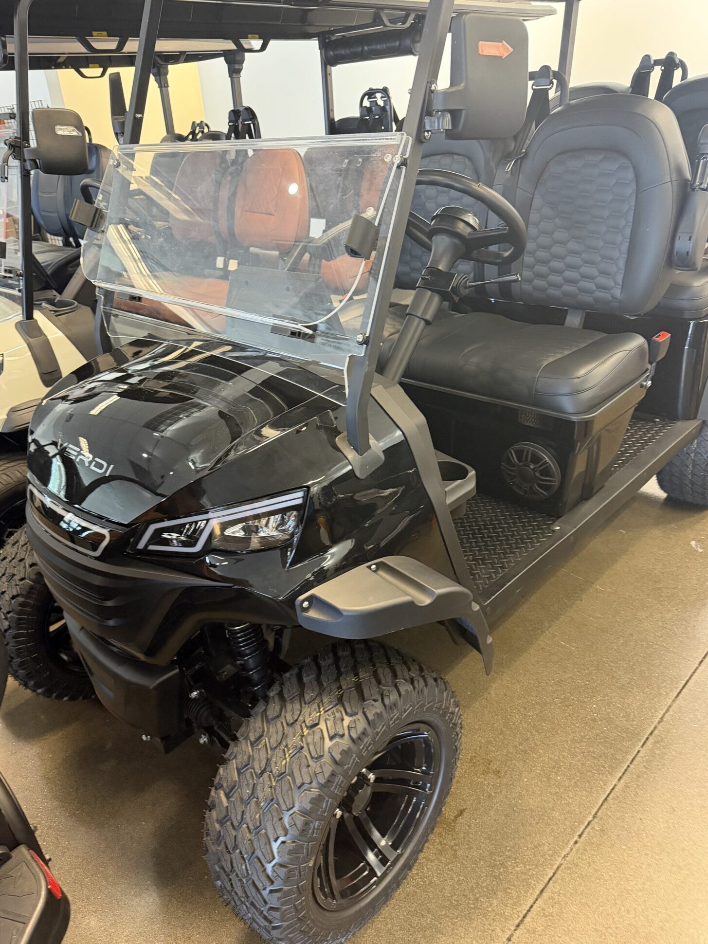 Blacked-out lifted EPIC golf cart with all-terrain tires and dark wheels